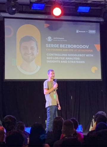 JetOctopus co-founder Serge Bezborodov speaking on stage at a search marketing conference